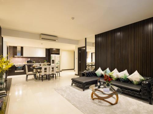 a living room with a couch and a table at The Costa Nha Trang Residences in Nha Trang