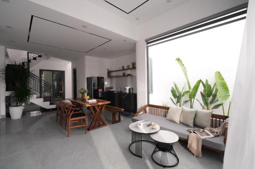 a living room with a couch and a table at Nhà Nhím in Da Lat