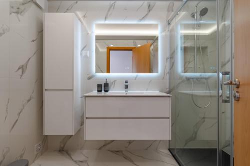 a bathroom with a sink and a shower at Breathtaking Coral Ocean View Apartment at OA in Portimão