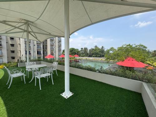 a patio with a table and chairs and an umbrella at Elixia 3C'S by Planet Path in Sri Jayewardenepura Kotte