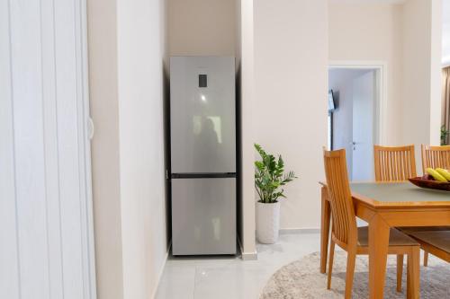 a refrigerator in a dining room with a table at Natalia's Nest in Ampavris