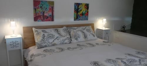 a bedroom with a bed with two lamps on it at Perla de Mar a 20m dalla spiaggia in Letojanni