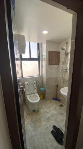 a bathroom with a toilet and a sink and a tub at Suite Stay in Kathmandu