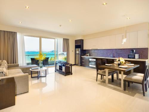 a kitchen and living room with a couch and a table at The Costa Nha Trang Residences in Nha Trang