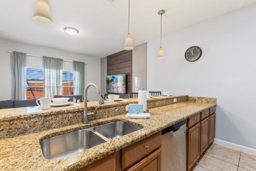 a kitchen with a sink and a counter top at 8893 Candy Palm Road in Kissimmee