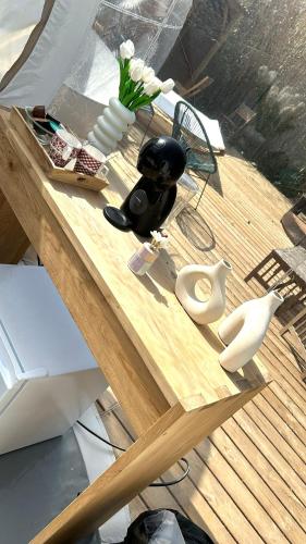 une table en bois avec des fleurs et des vases. dans l'établissement Les bulles Nîmoises, à Nîmes