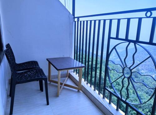 a chair and a table on a balcony at HOTEL GRAND HILL ,MALL ROAD ,Mcleodganj in Dharmsala