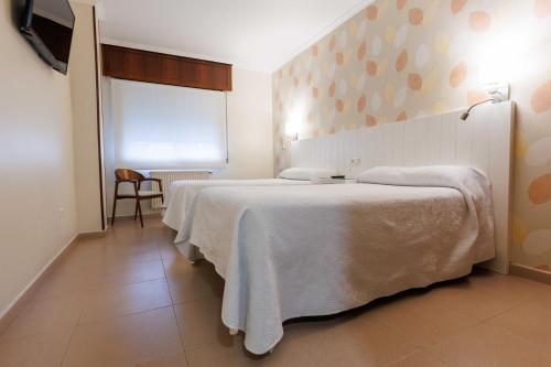 Letto o letti in una camera di Hotel O Cruceiro