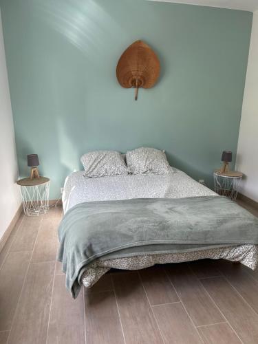 a bedroom with a bed and two end tables at Chambre chez l'habitant in Séné