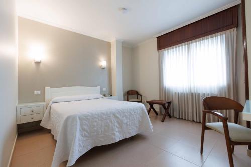 Letto o letti in una camera di Hotel O Cruceiro