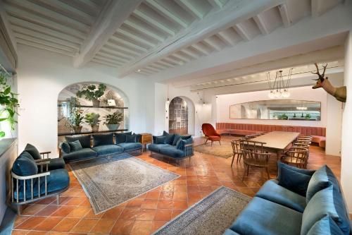 a living room with blue couches and a table at Il Casolese, Private Pool, Nature, Greve In Chianti in Greve in Chianti
