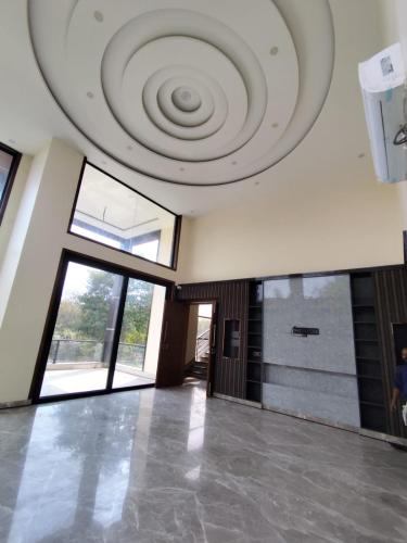 a large room with a ceiling with a spiral at Sunrise vista Near expo center in Greater Noida