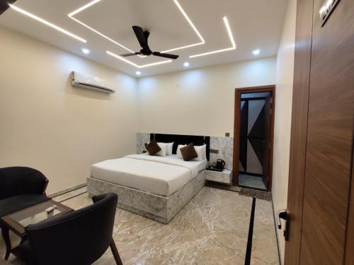 a bedroom with a bed and a ceiling fan at Sunrise vista Near expo center in Greater Noida