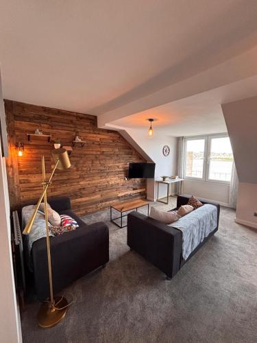 a living room with a bed and a couch at Stylish Coastal Apartment with Breathtaking views in Conwy