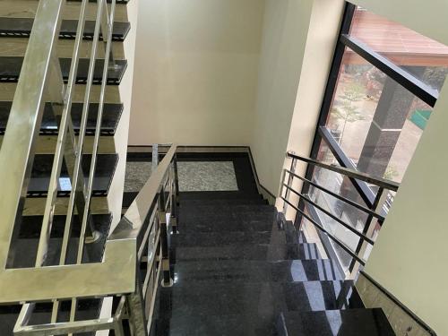 a staircase in a building with a window at Sunrise vista Near expo center in Greater Noida