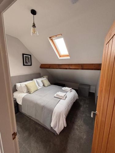 a bedroom with a bed with towels on it at Stylish Coastal Apartment with Breathtaking views in Conwy