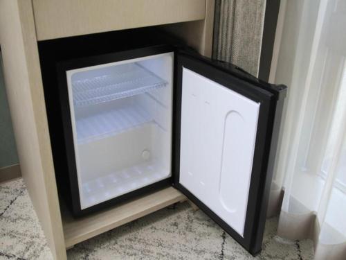 an empty refrigerator in a corner of a room at Richmond Hotel Morioka Ekimae in Morioka