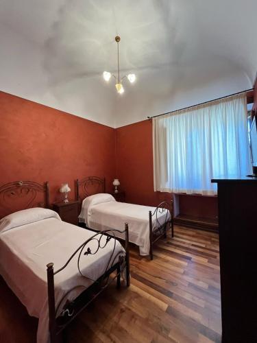 a room with two beds and a window at Agriturismo Tenute Spartà in Randazzo