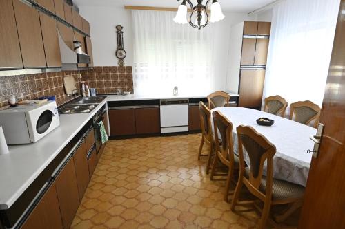a kitchen with a table and chairs in it at Vikend Kuća Živković in Despotovac