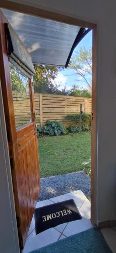 an open door to a yard with a fence at The Centre Circle in Hilton