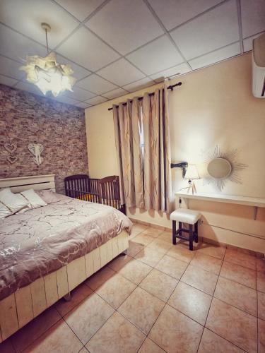 a bedroom with a bed and a table and a mirror at Mamas Summer House in Larnaca
