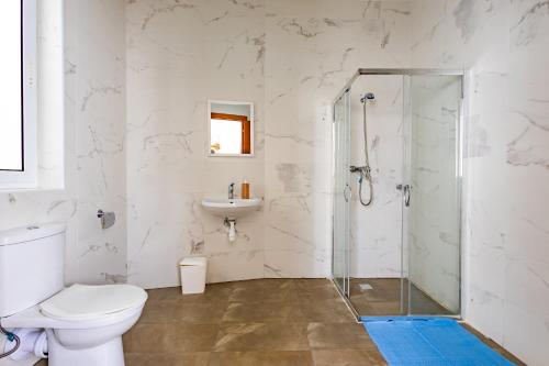 a bathroom with a toilet and a sink and a shower at Sea View & Private Terrace Near Promenade -Sleep 8 by QuickTrips in St. Paul's Bay