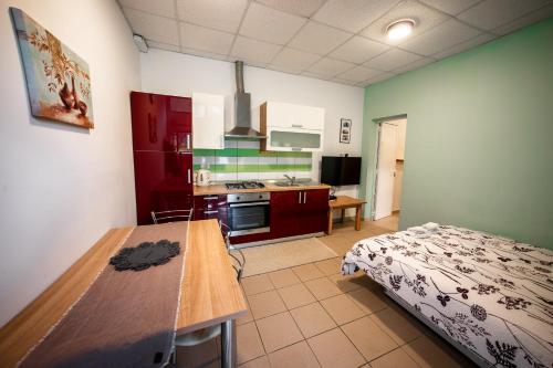 a kitchen with a table and a bed in a room at Apartma Kamp Ajdovščina in Ajdovščina