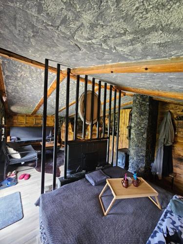 a bedroom with a bed and a table at Zemljane kućice Kreševo in Kreševo