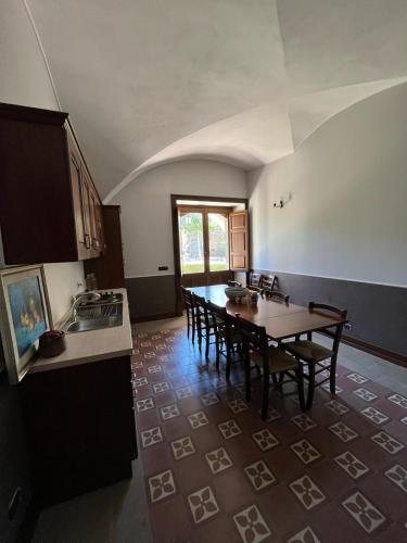 a kitchen with a table and chairs in a room at Agriturismo Tenute Spartà in Randazzo