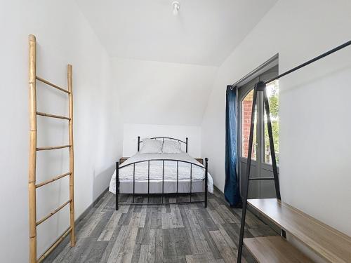 a bedroom with a bed in a room with a window at Loft cosy jaccuzi & terrasse in Glisy