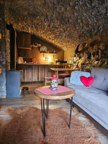 a living room with a couch and a table at Zemljane kućice Kreševo in Kreševo