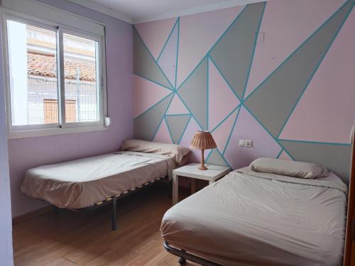 Postel nebo postele na pokoji v ubytování apartamento Daimuz playa