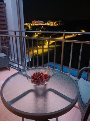 a bowl of fruit on a glass table on a balcony at Ra-C&C in Vrdnik