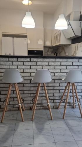 two stools sitting in front of a kitchen counter at Cozy house Luana in Lopud Island