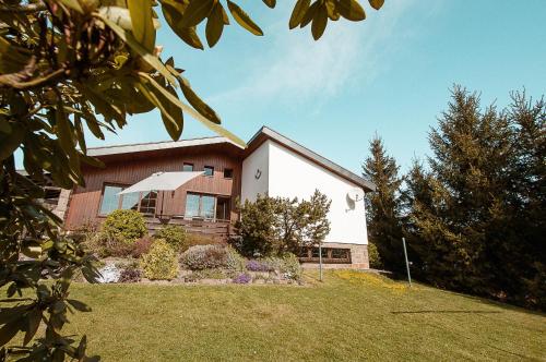 a house with a lawn in front of it at Ferienhaus Tannenblick Rochlitz in Rochlitz