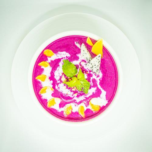 a pink bowl of food on a white plate at Lub d Siem Reap - Near Pub Street & Angkor Wat in Siem Reap