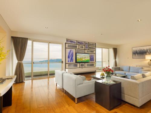a living room with a couch and a table at The Costa Nha Trang Residences in Nha Trang