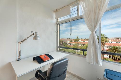 a desk in a room with a window at Casa Candido in Arona