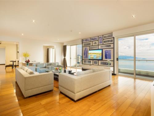 a living room with two couches and a television at The Costa Nha Trang Residences in Nha Trang