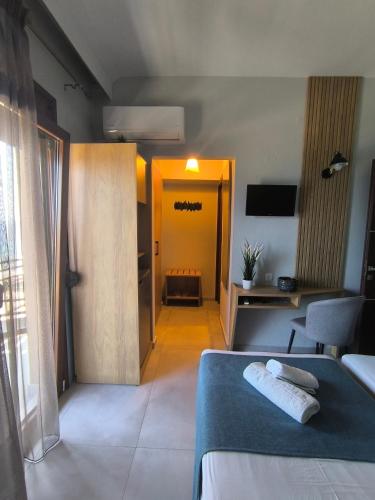 a hotel room with a bed and a hallway at Maria rooms to let Ouranoupoli in Ouranoupoli