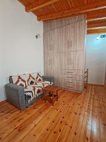 a living room with a couch and a table at Traditional house in the centre of Kymi in Kymi