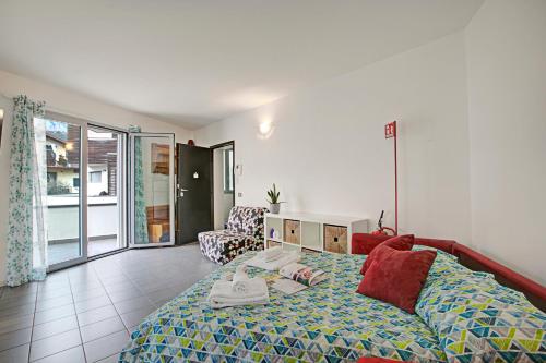 a bedroom with a bed and a living room at Rosy & Onyx House With Shared Pool in Toscolano Maderno