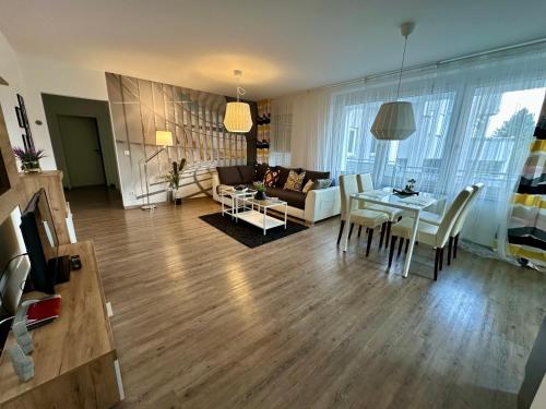 a living room with a table and a couch at Time Out Apartments in Herzogenaurach