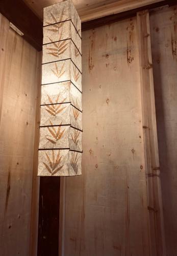 a light hanging from a wall in a room at maison Rose & Jardinier eco homestay in Sa Pa
