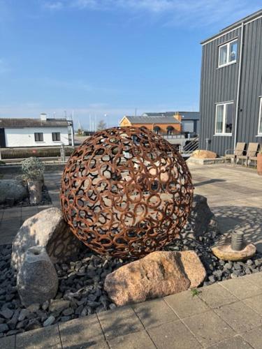 a large metal object sitting on a pile of rocks at Bogense Feriebo in Bogense