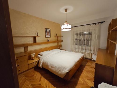 a bedroom with a large bed and a window at Casa Rizzi in Campitello di Fassa