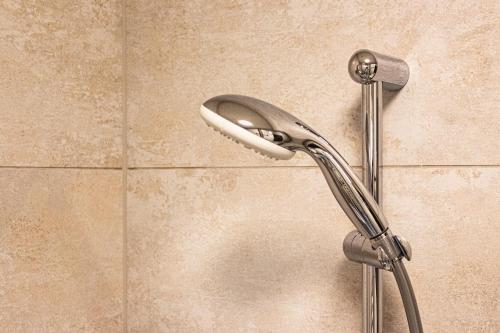 a shower head on a wall in a bathroom at RIOpartment Ossiacher See in Bodensdorf