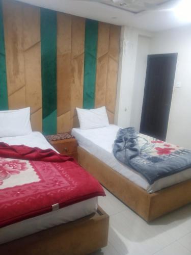 Ένα ή περισσότερα κρεβάτια σε δωμάτιο στο Libra Hotel Islamabad