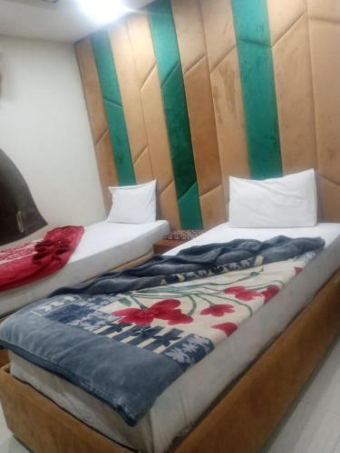 Ένα ή περισσότερα κρεβάτια σε δωμάτιο στο Libra Hotel Islamabad