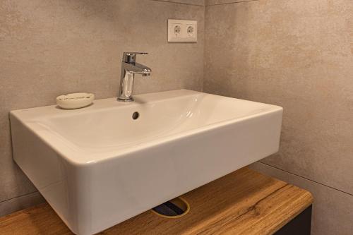 a white sink in a bathroom with a counter at RIOpartment Ossiacher See in Bodensdorf